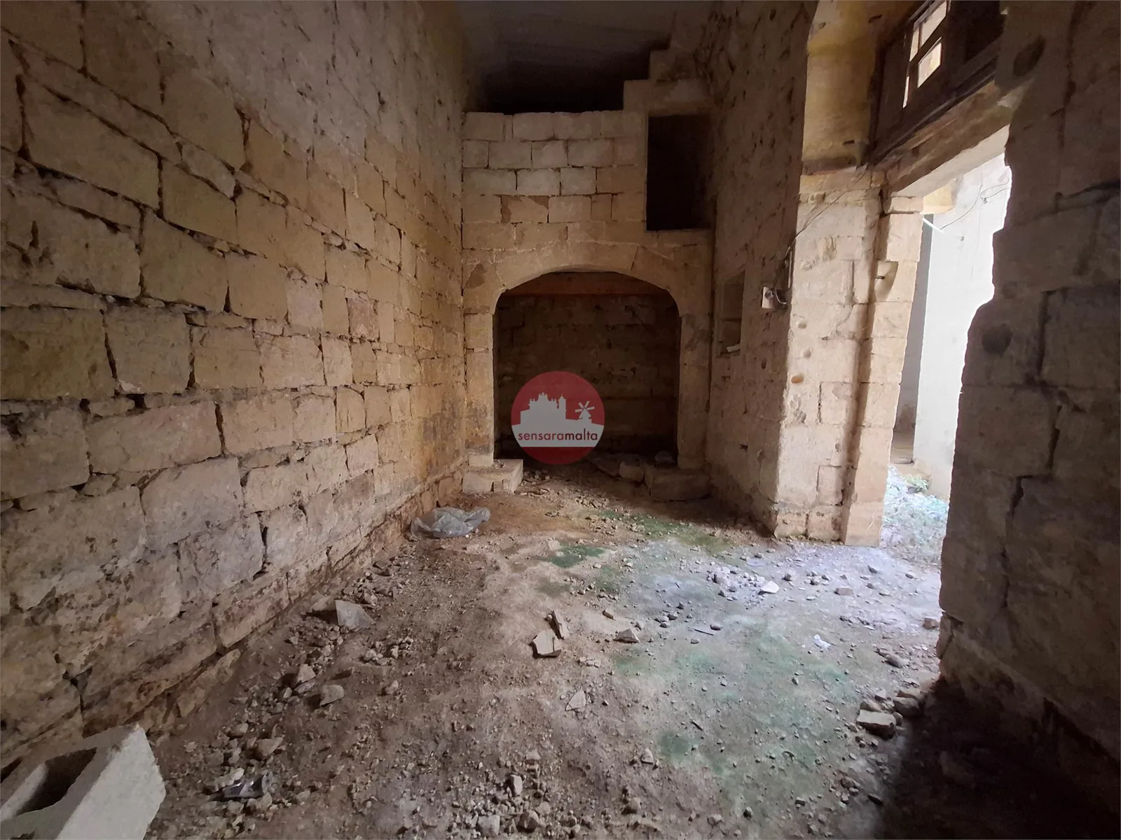 Historic limestone room with exposed stone walls, archway and traditional architectural details