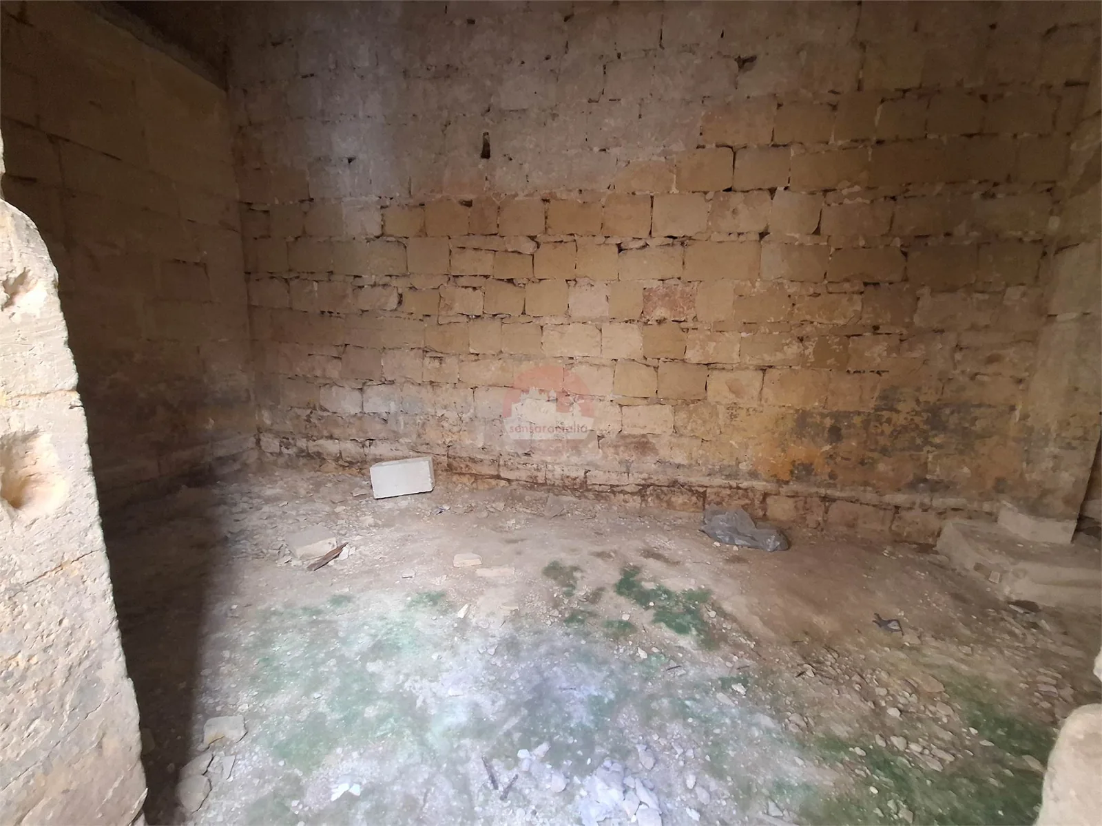 Unfinished limestone room showing the original stonework